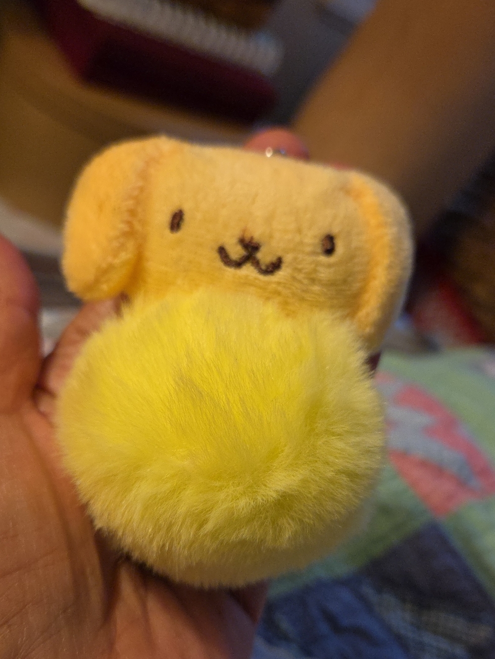 Sanrio Pompompurin plush keychain with a fluffy pom-pom